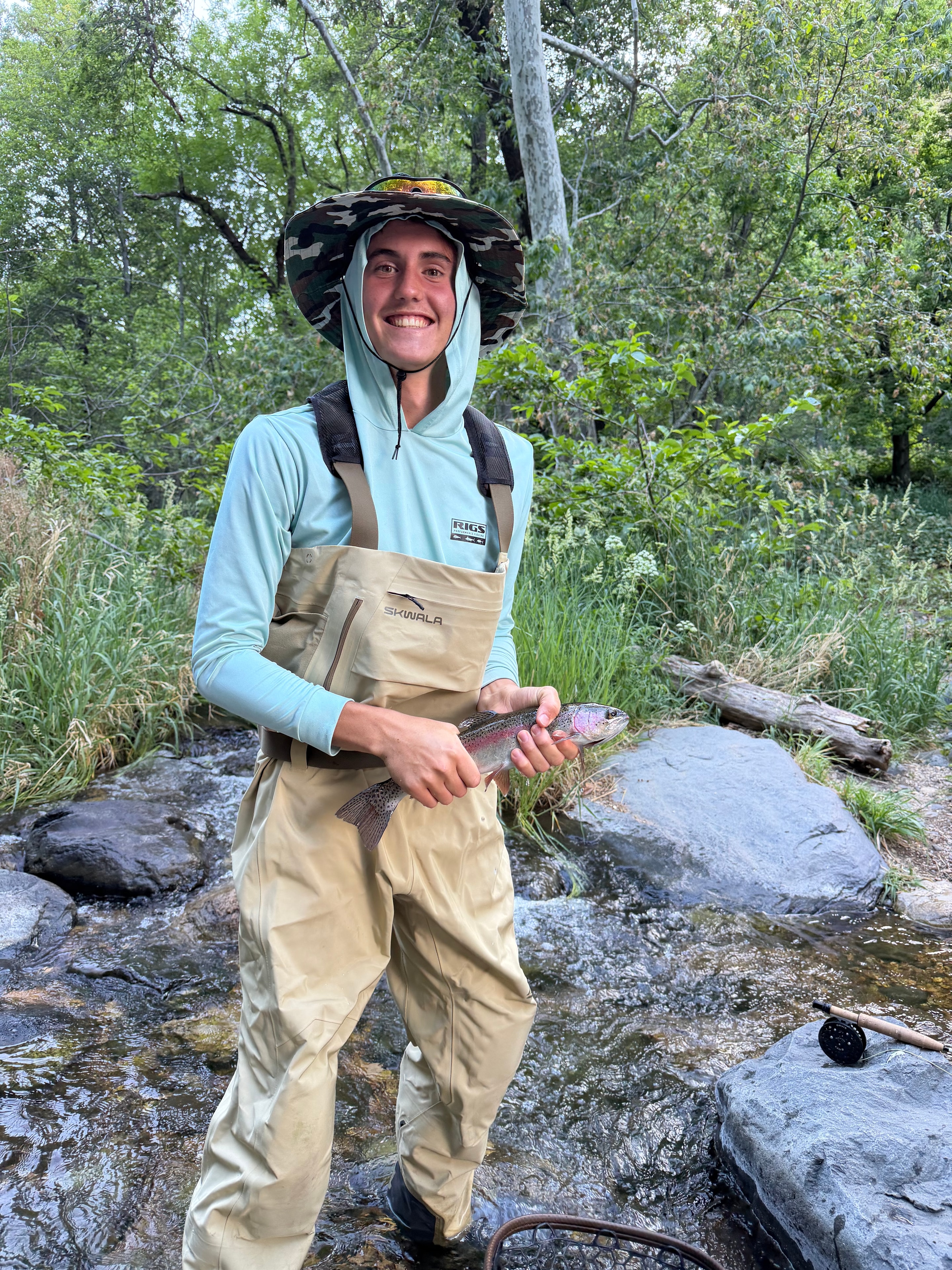 Rainbow trout held by angler