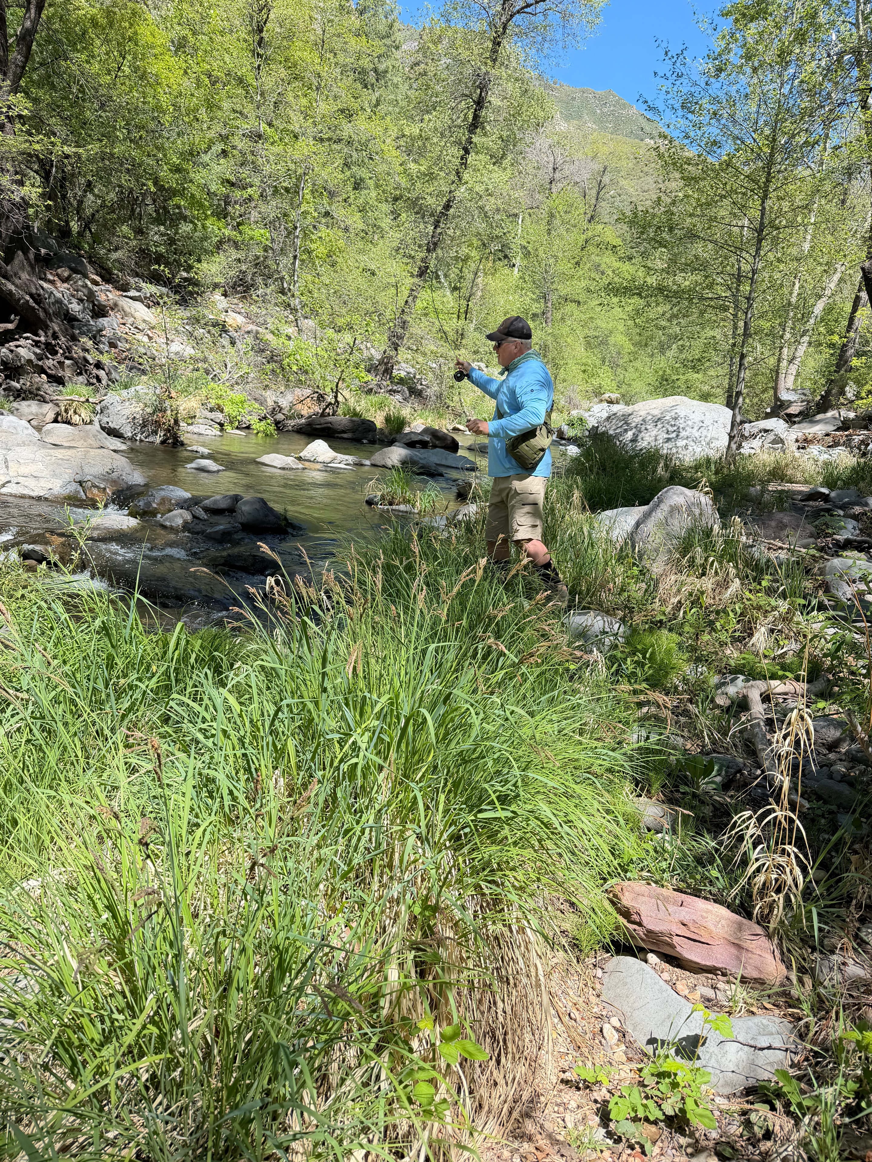 Fly fishing rod casting over river